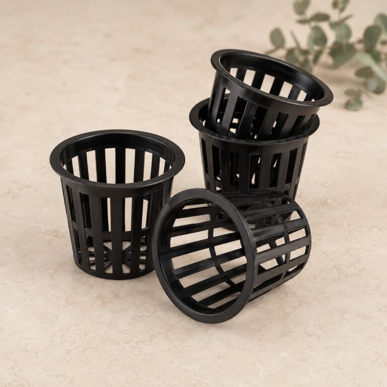Three standard black hydroponic net pots on a neutral surface